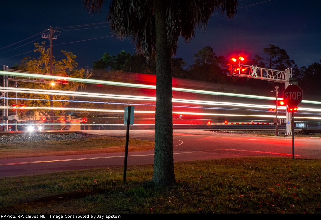 M210 (Baldwin to Cincinnati autoracks) streaks north through Folkston  